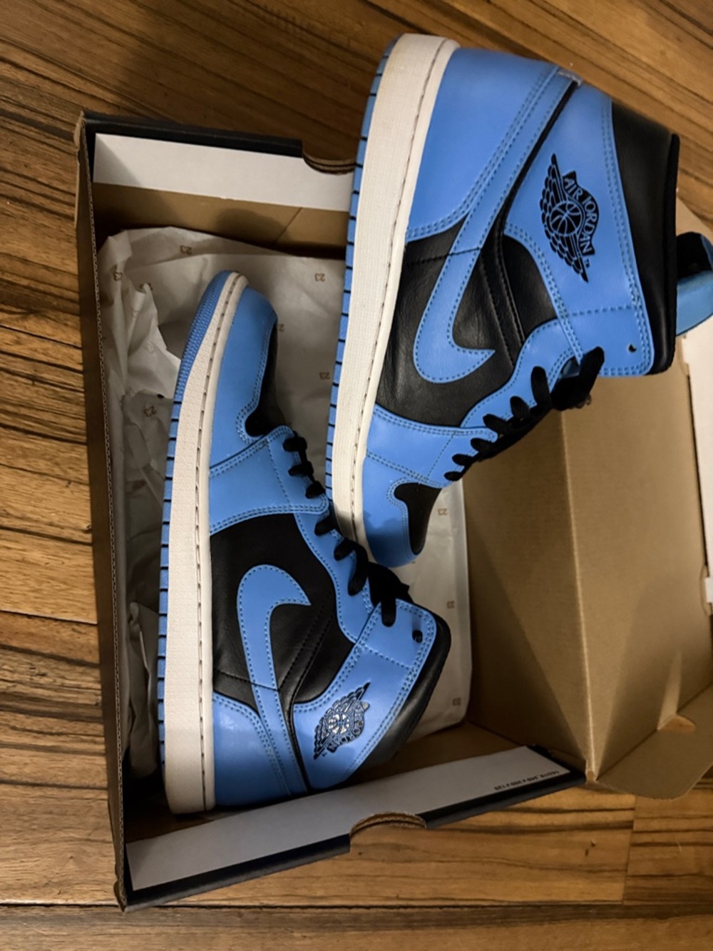 Jordan Men’s High-Top Sneakers in Light Blue and Black.